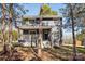 Charming two-story home with a covered front porch, surrounded by mature trees, offering a serene setting at 14325 Rocky River E Rd, Davidson, NC 28036