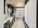 Stylish kitchen with stainless steel appliances, marble countertops, and wooden accent, seamlessly connects to dining at 14325 Rocky River E Rd, Davidson, NC 28036