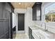 Updated kitchen featuring modern appliances, white marble countertops, and black cabinetry for a sleek design at 14325 Rocky River E Rd, Davidson, NC 28036