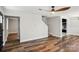 Open-concept living room showcasing hardwood floors, a ceiling fan, and seamless transition to the kitchen at 14325 Rocky River E Rd, Davidson, NC 28036