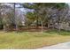 Expansive backyard featuring a partial wood fence, mature trees and lush, green lawn at 1541 Arborgate Dr, Rock Hill, SC 29732