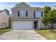 Charming two-story home featuring neutral siding, black shutters, a two-car garage, and a well-maintained front lawn at 1541 Arborgate Dr, Rock Hill, SC 29732