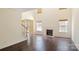 Spacious living room featuring hardwood floors, fireplace, and staircase at 1541 Arborgate Dr, Rock Hill, SC 29732