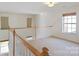 Cozy loft area with large windows and neutral carpet, perfect as a study or play area at 1541 Arborgate Dr, Rock Hill, SC 29732