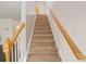 Carpeted staircase with wooden banister and handrail leading to the upper level of the home at 1541 Arborgate Dr, Rock Hill, SC 29732
