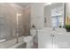Modern bathroom with a glass-enclosed shower, white vanity, and neutral tile, creating a clean and bright space at 1645 Unison Dr, Charlotte, NC 28262