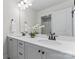 Bright bathroom featuring a double vanity with white countertops, grey cabinets and a large mirror at 1645 Unison Dr, Charlotte, NC 28262
