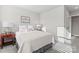 Bright bedroom featuring natural light from two windows, a bed, and a side table with a lamp at 1645 Unison Dr, Charlotte, NC 28262