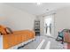 Cozy bedroom with natural light, a comfy twin bed, chair, and door to an outdoor balcony at 1645 Unison Dr, Charlotte, NC 28262