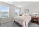 Bright bedroom featuring natural light from two windows, a bed, and a side table with a lamp at 1645 Unison Dr, Charlotte, NC 28262