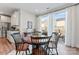 Bright dining area features a wood table, seating for four, and sliding doors to the outdoor deck at 1645 Unison Dr, Charlotte, NC 28262