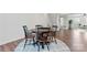 Dining area features a wood table, seating for four, and a patterned rug at 1645 Unison Dr, Charlotte, NC 28262