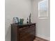 Dresser with three drawers and a top shelf, complete with decor and a window for natural light at 1645 Unison Dr, Charlotte, NC 28262
