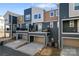 Rear exterior of new townhomes featuring individual balconies and driveways with modern designs at 1645 Unison Dr, Charlotte, NC 28262