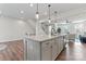 Spacious kitchen island with sink, granite countertop, pendant lighting, and open to the living area at 1645 Unison Dr, Charlotte, NC 28262