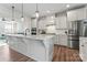 Open-concept kitchen with a large island, stainless steel appliances, and seamless flow to the living room at 1645 Unison Dr, Charlotte, NC 28262