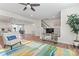 Open living area showcasing the modern staircase, TV console, and seamless flow to the dining area at 1645 Unison Dr, Charlotte, NC 28262