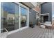 A cozy outdoor patio features stylish wicker furniture and a sliding glass door to the interior at 1645 Unison Dr, Charlotte, NC 28262