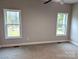 Bedroom with carpeted floors, two large windows, and neutral paint, ready for personal touches at 203 S Hill Ave # 3, Albemarle, NC 28001