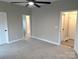 This spacious bedroom includes a ceiling fan, carpet flooring, and a neutral color palette at 203 S Hill Ave # 3, Albemarle, NC 28001