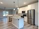 Well-lit kitchen with granite counters, stainless appliances, ample cabinets and a center island overlooking an open floorplan at 203 S Hill Ave # 3, Albemarle, NC 28001