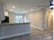 Open-concept kitchen featuring a breakfast bar, modern lighting, and new appliances with wood-look vinyl flooring at 203 S Hill Ave # 3, Albemarle, NC 28001