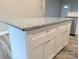 Granite topped kitchen island offers extra storage and counter space in this bright modern kitchen at 203 S Hill Ave # 3, Albemarle, NC 28001
