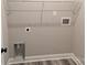 Interior laundry room with shelving and hookups ready for appliances; new construction at 203 S Hill Ave # 3, Albemarle, NC 28001