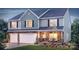 Two story home with a three car garage, stone accents and a well manicured lawn at 216 Giant Oak Ave, Statesville, NC 28677