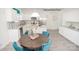 Well-lit kitchen with stainless steel appliances, lots of storage, and a wooden table at 216 Giant Oak Ave, Statesville, NC 28677