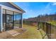 Beautiful backyard featuring a screened-in porch, lush green grass, and a black fence, ideal for outdoor enjoyment at 2802 15Th Avenue Se Pl, Hickory, NC 28602