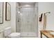 Modern bathroom showcasing tiled walls, a glass-enclosed shower, and a toilet with coordinating accessories at 2802 15Th Avenue Se Pl, Hickory, NC 28602