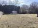 Large grassy backyard with privacy bushes and a storage shed; partially fenced at 2883 Westfield Nw Ave, Concord, NC 28027