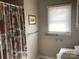 Functional bathroom featuring neutral walls, tiled flooring, and a window at 2883 Westfield Nw Ave, Concord, NC 28027