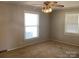 Neutral bedroom featuring carpeted floors, two large windows allowing for natural light and standard ceiling fan at 2883 Westfield Nw Ave, Concord, NC 28027