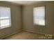 Neutral bedroom featuring carpeted floors, two large windows allowing for natural light at 2883 Westfield Nw Ave, Concord, NC 28027