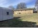 Single-story brick home with a spacious backyard, shed, and an attached carport at 2883 Westfield Nw Ave, Concord, NC 28027