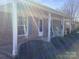 Inviting covered front porch with brick facade, rocking chairs and meticulously maintained landscaping at 2883 Westfield Nw Ave, Concord, NC 28027