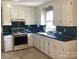 Functional kitchen featuring a classic range, ample counter space, and bright natural lighting at 2883 Westfield Nw Ave, Concord, NC 28027