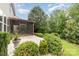 Backyard featuring a covered porch, privacy fence, and mature landscaping at 3004 Fallondale Rd, Waxhaw, NC 28173