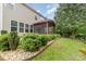 Backyard featuring a screened porch, lush landscaping and a stone garden bed border at 3004 Fallondale Rd, Waxhaw, NC 28173