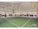 Indoor basketball court with high ceilings, brick columns, and plenty of natural light at 3004 Fallondale Rd, Waxhaw, NC 28173