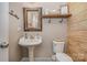 Charming powder room features a pedestal sink, toilet, and rustic wooden accents at 3004 Fallondale Rd, Waxhaw, NC 28173