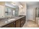 Bathroom features granite countertops, dual sinks, tile flooring, and framed mirrors at 3004 Fallondale Rd, Waxhaw, NC 28173