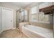 Bathroom with soaking tub, tiled shower with glass doors, and ample natural light at 3004 Fallondale Rd, Waxhaw, NC 28173