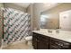 Bathroom with a shower-tub combo, tile flooring, and a dark vanity with a sink at 3004 Fallondale Rd, Waxhaw, NC 28173