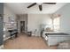 Bright bedroom with neutral carpet, ceiling fan, and natural light from a large window at 3004 Fallondale Rd, Waxhaw, NC 28173