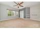 Bedroom with neutral carpet, grey accent wall, and a ceiling fan at 3004 Fallondale Rd, Waxhaw, NC 28173