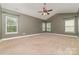 A neutral bedroom with vaulted ceilings has multiple windows for lots of natural light at 3004 Fallondale Rd, Waxhaw, NC 28173