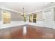 Spacious dining room featuring hardwood floors, wainscoting, and a view of the front yard at 3004 Fallondale Rd, Waxhaw, NC 28173